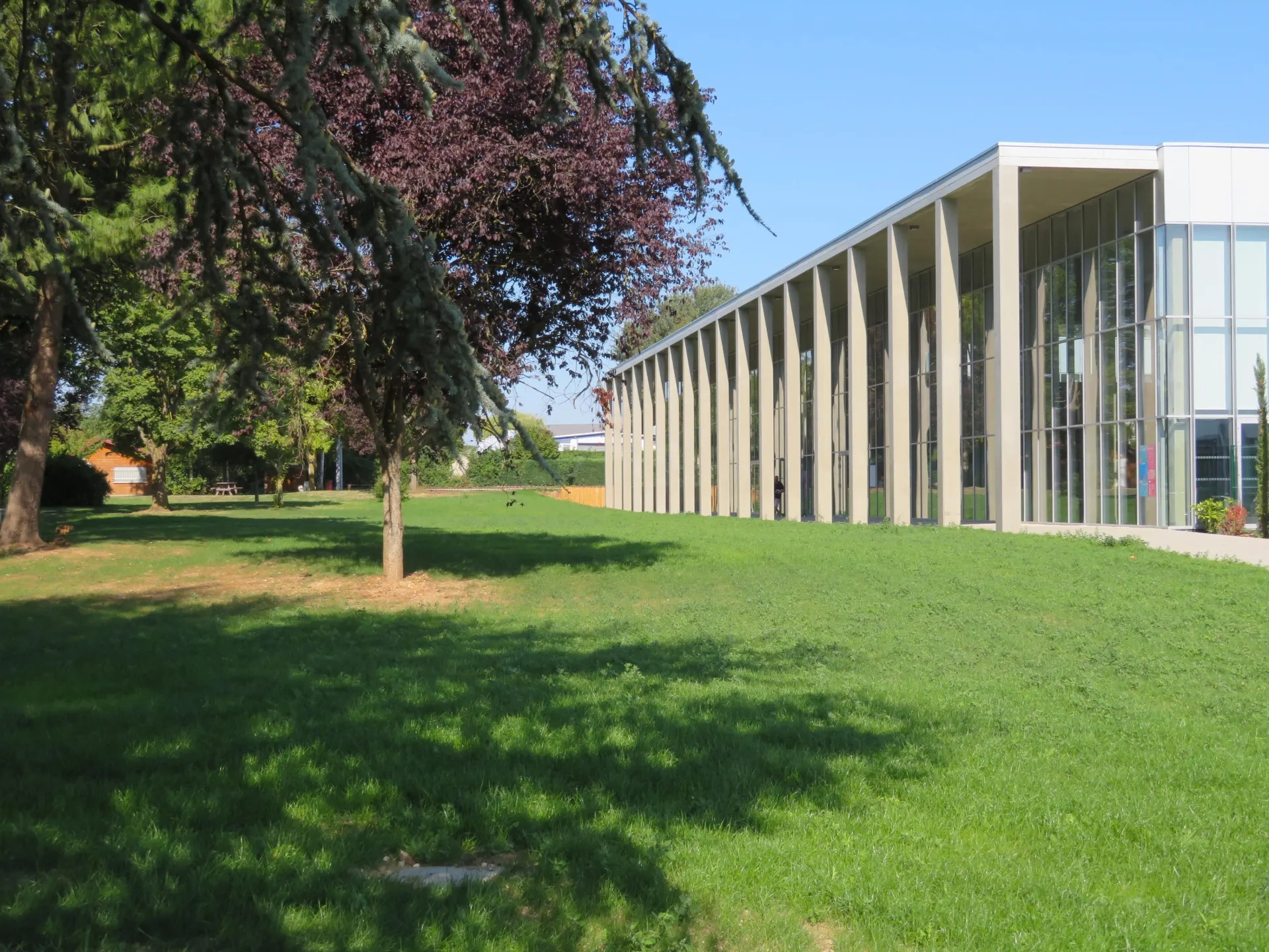 Colonnade de béton de la galerie- auvent dont les poteaux de section carrée ont les angles coupés. DEPRICK_MANIAQUE_Roye_Eqpt_Centre aquatique_P-Deprick_IMG_7718.jpg