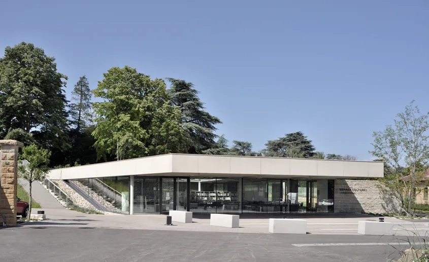 Légèrement encastré dans la pente naturelle du terrain, l’espace culturel s’inscrit avec harmonie et retenue entre le patrimoine historique du centre-ville et le parc de la mairie. Légèrement encastré dans la pente naturelle du terrain, l’espace culturel s’inscrit avec harmonie et retenue entre le patrimoine historique du centre-ville et le parc de la mairie.